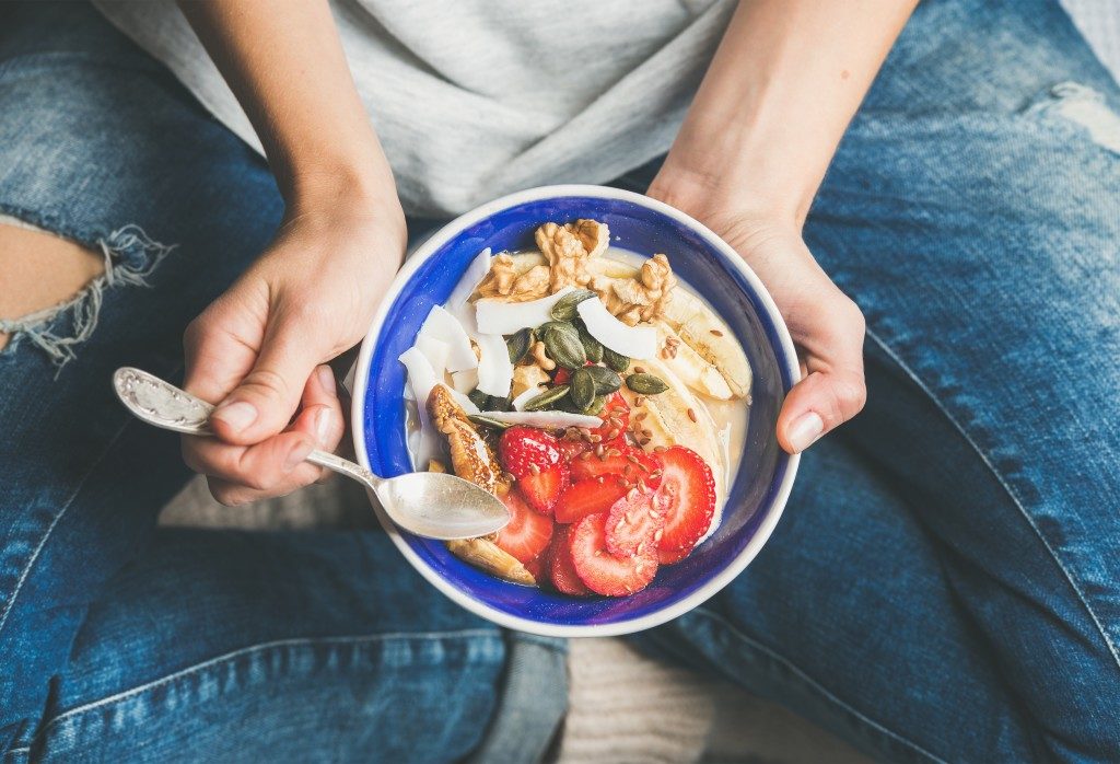 girl holding an oatmeal bowl