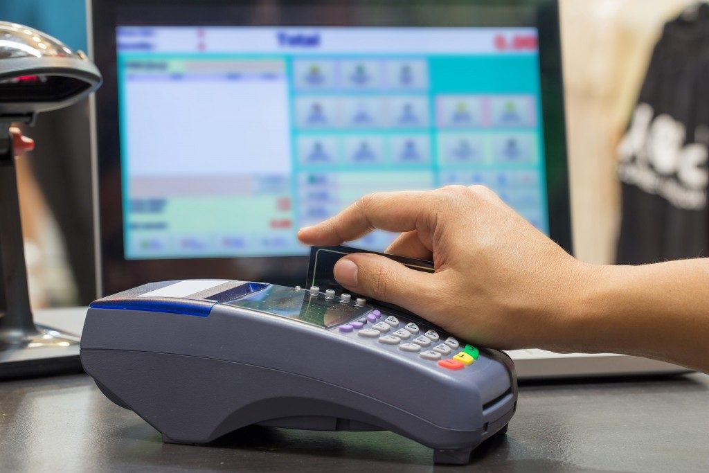 Hand Swiping Credit Card In Store