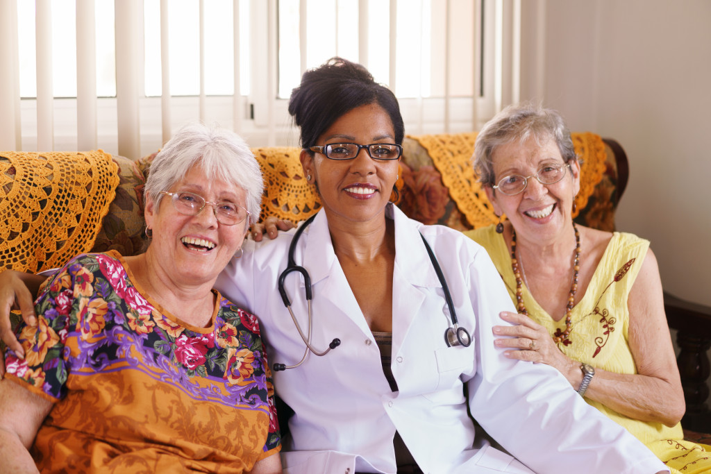 doctor seating with 2 senior women in a hospice